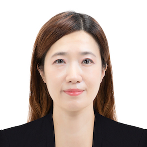 Headshot of Sooyeon Lee. Sooyeon is an Asian woman with long dark brown hair wearing a black suit jacket.