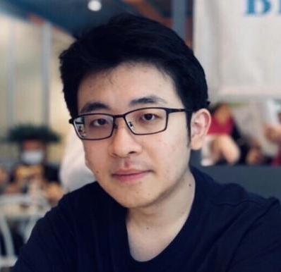 Yi-Hao Peng's selfie. A man with a pair of black glasses and black T-shirt sitting at the restaurant table.